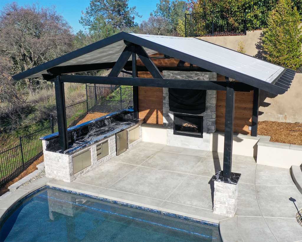 Outdoor living space with built-in grill and fire place
